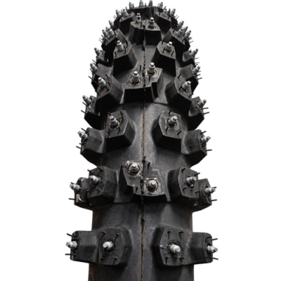 Mitas XT-444 tire with installed studs on a clean background